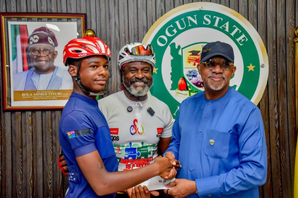 L-R: Master Kanye Tagbo-Okeke; his father, Mr Tagbo Okeke and the Ogun State Governor, Prince Dapo Abiodun during the presentation of a N20m cheque to the Cycling for Autism with KanyeChukwu team at the Governor's office, Oke-Mosan, Abeokuta on Tuesday.